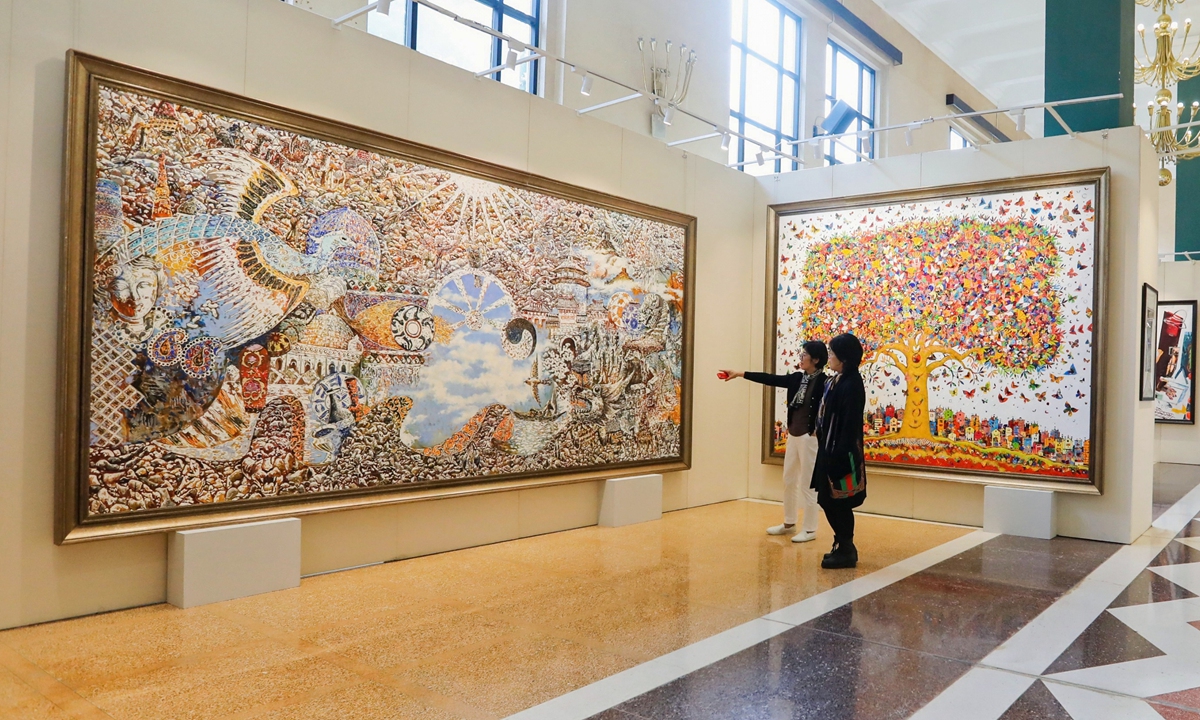 Visitors watch paintings in a BRI-inspired art exhibition in Beijing on October 16, 2023. Photo: Courtesy of the China National Society for the Promotion of Arts and Culture 