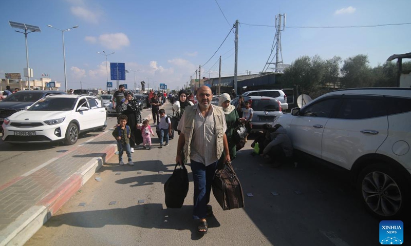 People arrive at the Rafah border crossing in the southern Gaza Strip city of Rafah, on Oct. 16, 2023. The Gaza-ruling Palestinian Islamic Resistance Movement (Hamas) on Monday denied reports that it had agreed to a temporary ceasefire with Israel in the Gaza Strip.(Photo: Xinhua)