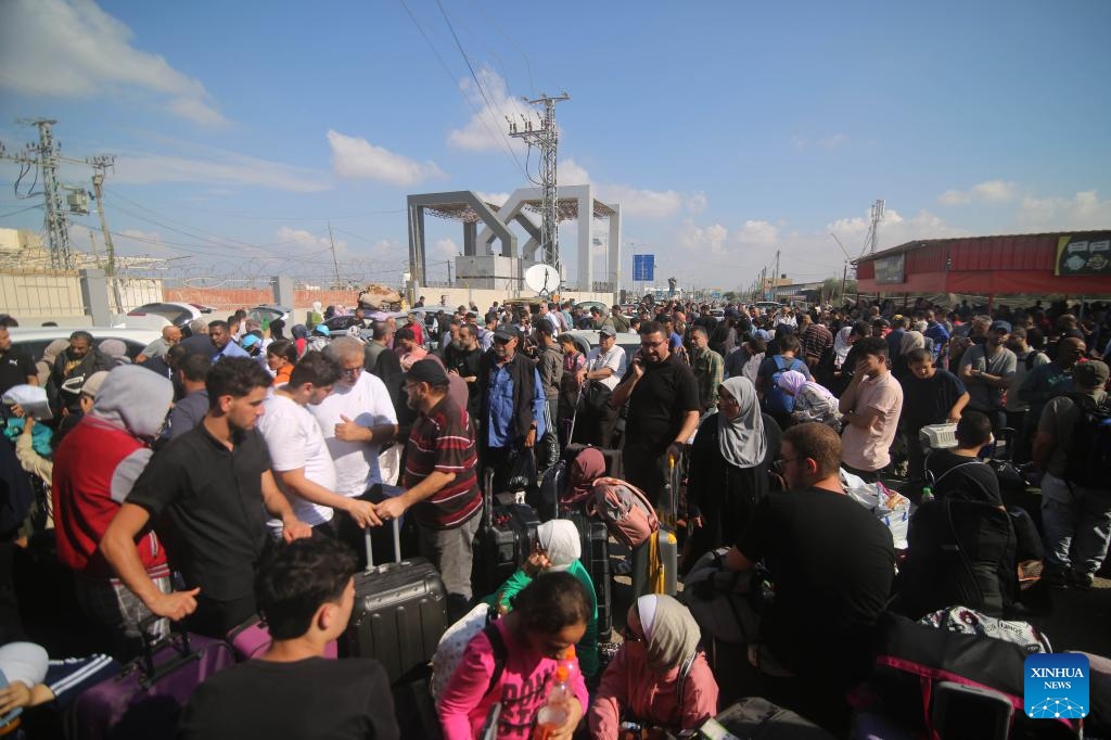 People wait for the opening of the Rafah border crossing in the southern Gaza Strip city of Rafah, on Oct. 16, 2023. The Gaza-ruling Palestinian Islamic Resistance Movement (Hamas) on Monday denied reports that it had agreed to a temporary ceasefire with Israel in the Gaza Strip.(Photo: Xinhua)