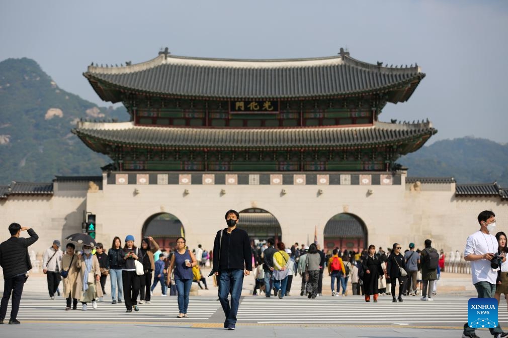 People cross a street in front of Gwanghwamun, the largest gate of Gyeongbokgung Palace in Seoul, South Korea, Oct. 18, 2023. Gyeongbokgung Palace's Gwanghwamun gate has opened to the public after being restored to its original state for the first time.(Photo: Xinhua)