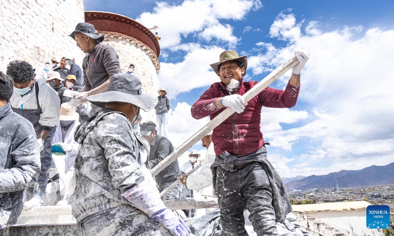 A worker stirs the paint during an annual renovation of the Potala Palace in Lhasa, southwest China's Tibet Autonomous Region, Oct. 18, 2023.(Photo: Xinhua)