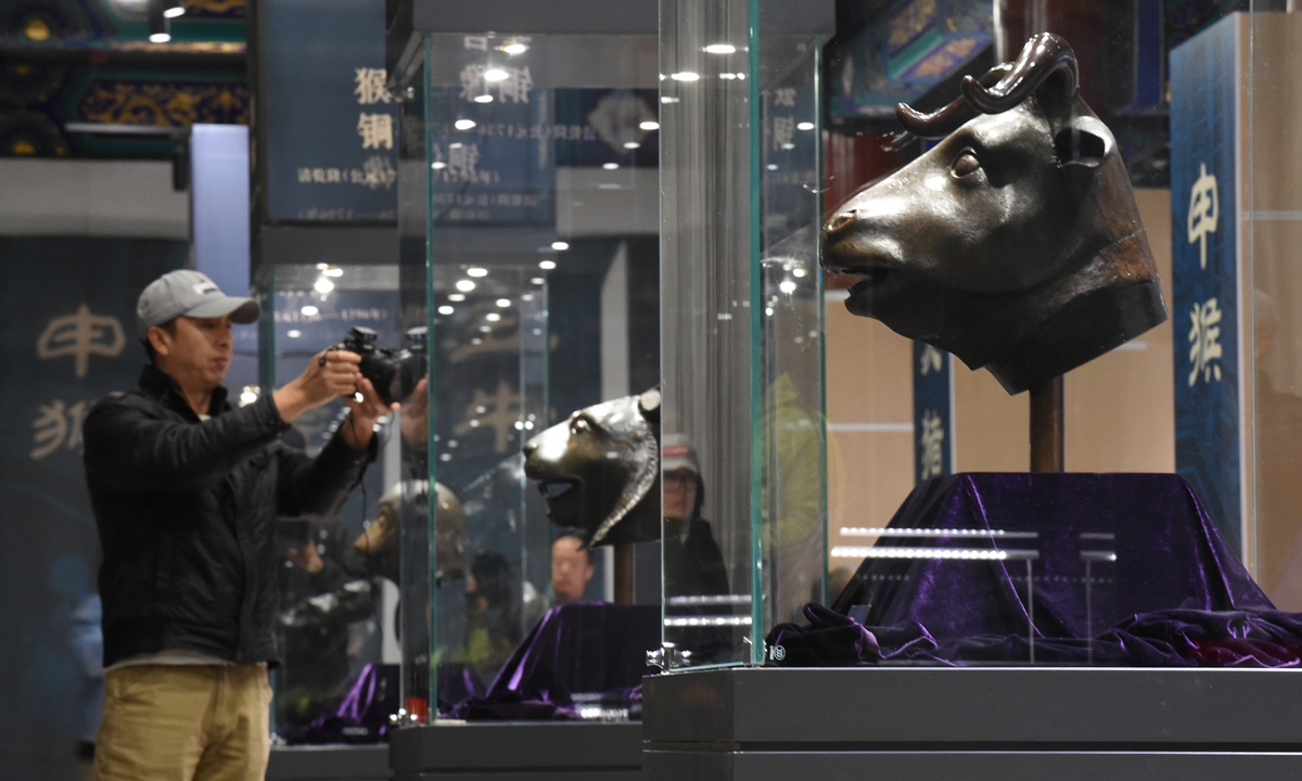 Visitors take pictures at a special exhibition of a set of bronze Chinese zodiac statues on display in Yuanmingyuan, or the Old Summer Palace in Beijing on October 20, 2023. The bronze heads were ripped from their statues when the Old Summer Palace was razed by British and French forces during the Second Opium War in 1860. Photo: Xinhua