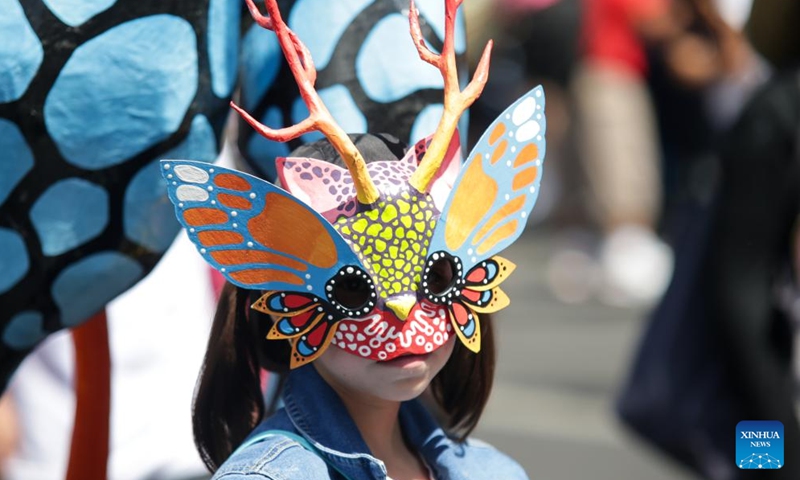 A masked person takes part in the Monumental Alebrijes Parade 2023 in Mexico City, capital of Mexico, Oct. 21, 2023. Alebrijes are brightly colored folk art sculptures of fantastical creatures. (Photo: Xinhua)