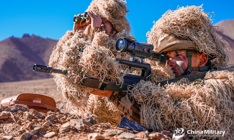 Scouts assigned to a reconnaissance element of an army regiment work together to sight in target during a tactical training exercise in mid-September, 2023. (eng.chinamil.com.cn/Photo by Meng Guoqiang)