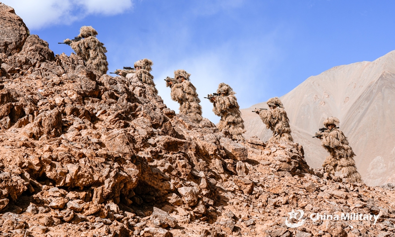 Scouts assigned to a reconnaissance element of an army regiment march in line on hillside during a tactical training exercise in mid-September, 2023. (eng.chinamil.com.cn/Photo by Meng Guoqiang)