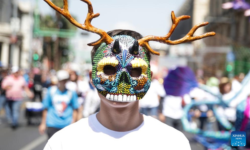 A masked person takes part in the Monumental Alebrijes Parade 2023 in Mexico City, capital of Mexico, Oct. 21, 2023. Alebrijes are brightly colored folk art sculptures of fantastical creatures. (Photo: Xinhua)