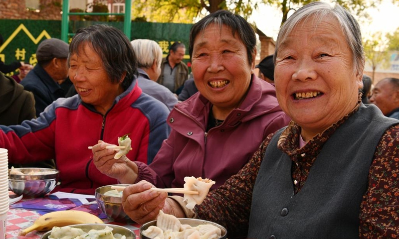 Elders eat dumplings at a cultural square in Donglizhuang Village of Luancheng District in Shijiazhuang, north China's Hebei Province, Oct. 22, 2023. The Chongyang Festival, also known as the Double Ninth Festival, is an annual festival to show respect and care for the elderly throughout China. The festival falls on the ninth day of the ninth Chinese lunar month, which is October 23 this year. (Photo: Xinhua)