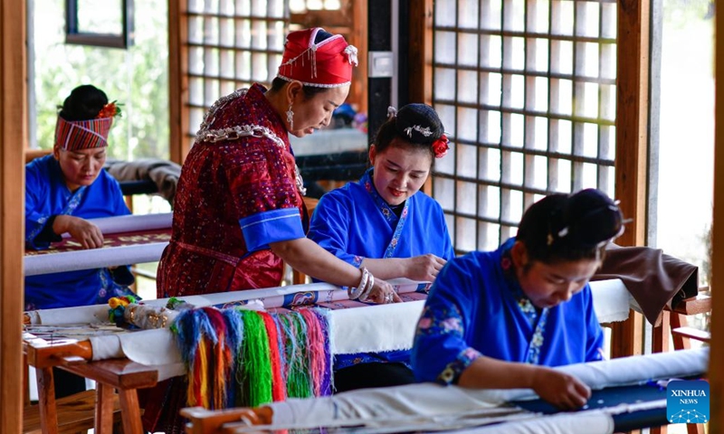 Long Luying (2nd L) communicates with her employees at the workshop in Shibing County of Qiandongnan Miao and Dong Autonomous Prefecture, southwest China's Guizhou Province, Oct. 18, 2023. (Photo: Xinhua)