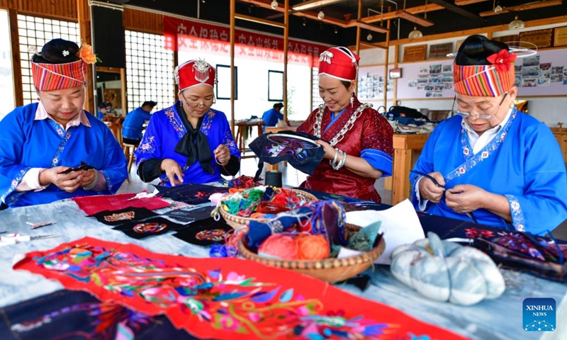 Long Luying (2nd R) and her employees make embroidery at the workshop in Shibing County of Qiandongnan Miao and Dong Autonomous Prefecture, southwest China's Guizhou Province, Oct. 18, 2023. (Photo: Xinhua)