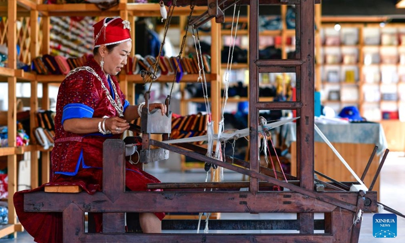 Long Luying spins thread at the workshop in Shibing County of Qiandongnan Miao and Dong Autonomous Prefecture, southwest China's Guizhou Province, Oct. 18, 2023. (Photo: Xinhua)