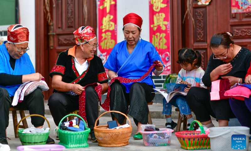 Long Luying (C) talks with villagers about embroidery skills at Xiaohe Village of Shibing County, Qiandongnan Miao and Dong Autonomous Prefecture, southwest China's Guizhou Province, Oct. 18, 2023. (Photo: Xinhua)