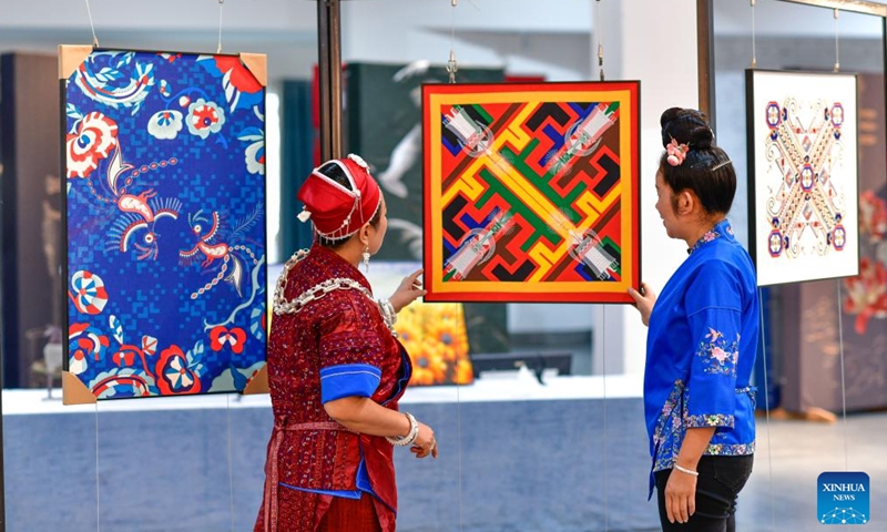 Long Luying (L) and her employee check Miao embroidery decorations at the workshop in Shibing County of Qiandongnan Miao and Dong Autonomous Prefecture, southwest China's Guizhou Province, Oct. 18, 2023. (Photo: Xinhua)