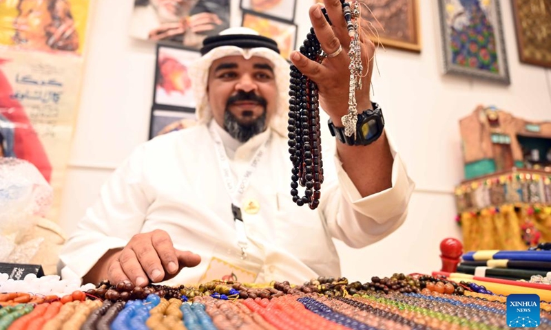 A craftsman displays rosaries during an exhibition featuring craft work which highlights Kuwaiti heritage in Hawalli Governorate, Kuwait, Oct. 22, 2023.(Photo: Xinhua)