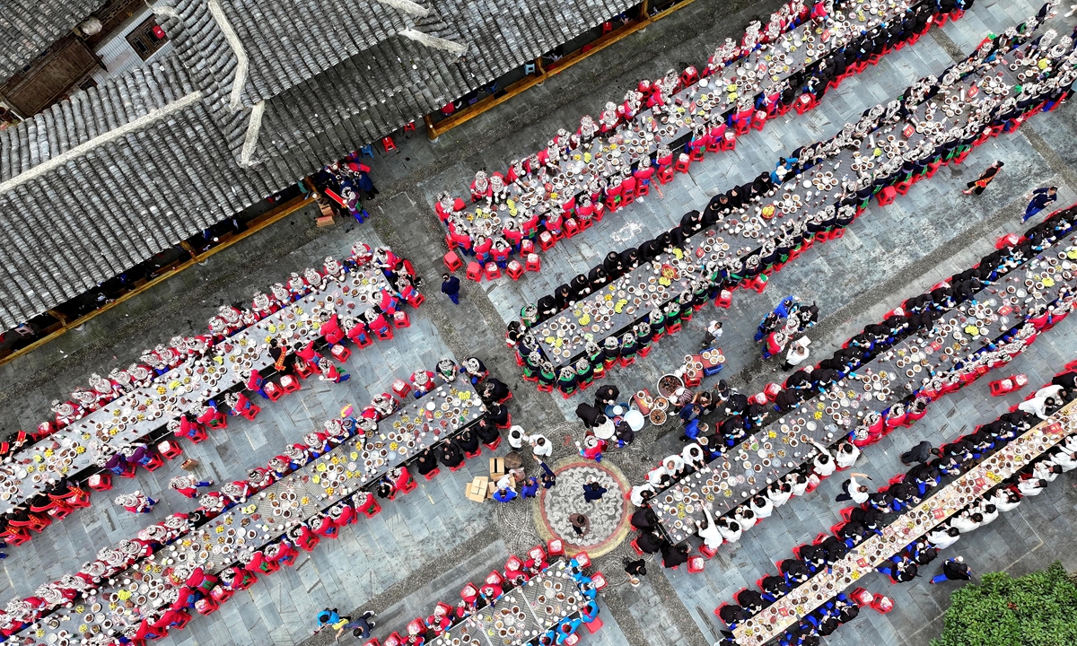 Villagers of the Dong ethnic group in Pingqiu township in Southwest China's Guizhou Province hold long-table banquets to celebrate the Anwa Festival on October 25, 2023. In the first nine months, the province featuring karst landscapes saw its tourist revenue increase by 35.9 percent year-on-year. Photo: VCG