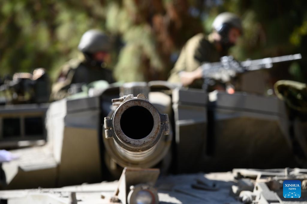 Israeli soldiers are seen on a Merkava tank at a position in northern Israel bordering Lebanon, on Oct. 25, 2023. The Lebanon-Israel border witnessed increased tension recently after Lebanese armed group Hezbollah fired dozens of rockets toward Shebaa Farms on Oct. 8 in support of the Hamas attacks on Israel the previous day, prompting the Israeli forces to respond by firing heavy artillery toward several areas in southeastern Lebanon.(Photo: Xinhua)