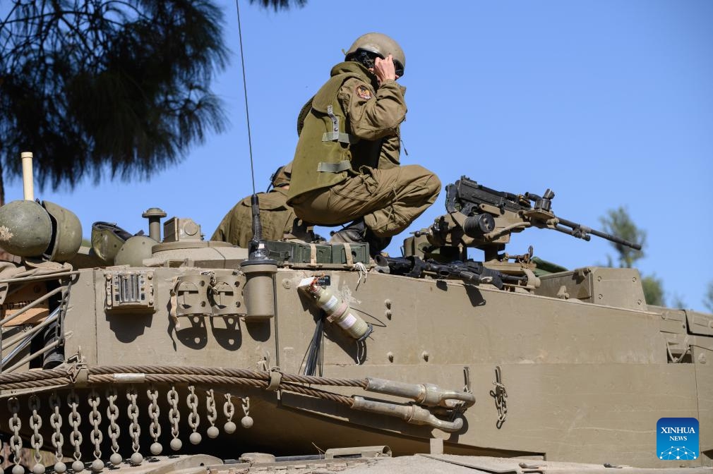 Israeli soldiers are seen on a Merkava tank at a position in northern Israel bordering Lebanon, on Oct. 25, 2023. The Lebanon-Israel border witnessed increased tension recently after Lebanese armed group Hezbollah fired dozens of rockets toward Shebaa Farms on Oct. 8 in support of the Hamas attacks on Israel the previous day, prompting the Israeli forces to respond by firing heavy artillery toward several areas in southeastern Lebanon.(Photo: Xinhua)