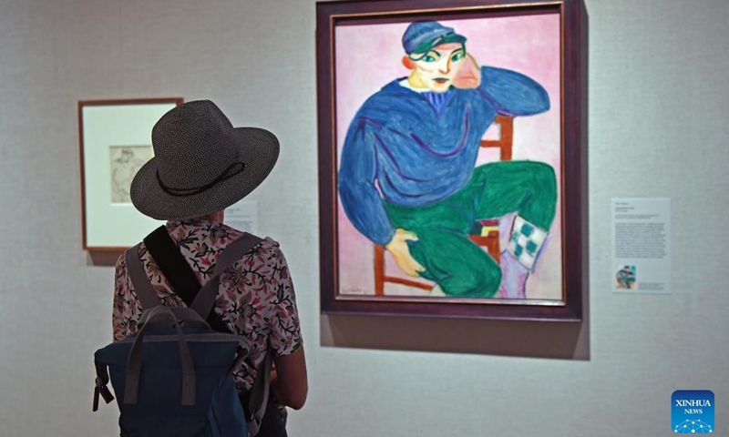 A visitor views Henri Matisse's artwork Young Sailor II during the exhibition Vertigo of Color: Matisse, Derain, and the Origins of Fauvism at the Metropolitan Museum of Art in New York, the United States, on Oct. 26, 2023. (Photo: Xinhua)