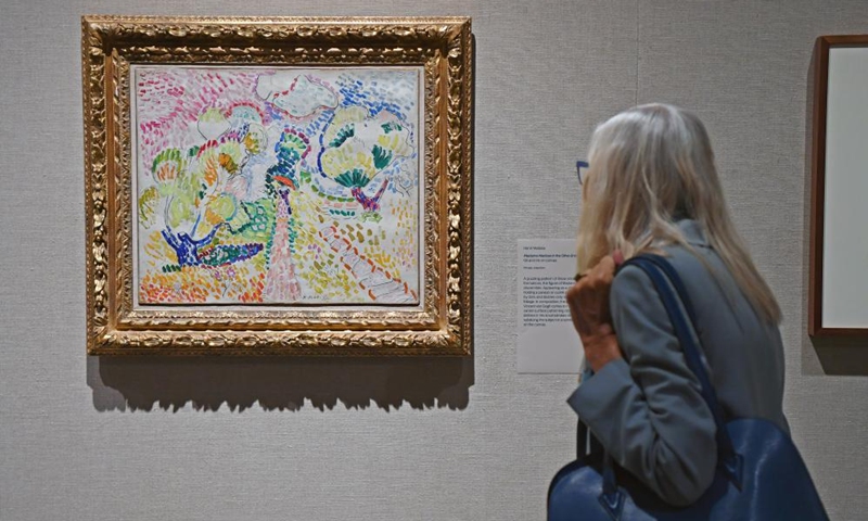 A visitor views Henri Matisse's artwork Madame Matisse in the Olive Grove during the exhibition Vertigo of Color: Matisse, Derain, and the Origins of Fauvism at the Metropolitan Museum of Art in New York, the United States, on Oct. 26, 2023. (Photo: Xinhua)