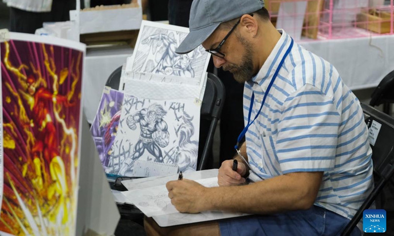 A man draws during the Malta Comic Con at the Malta Fairs and Conventions Center in Ta'Qali, Malta, Oct. 28, 2023. (Photo: Xinhua)