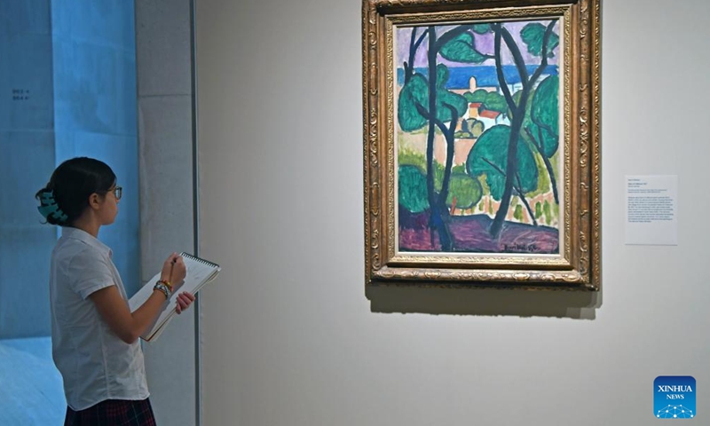 A girl makes a sketch of Henri Matisse's artwork View of Collioure during the exhibition Vertigo of Color: Matisse, Derain, and the Origins of Fauvism at the Metropolitan Museum of Art in New York, the United States, on Oct. 26, 2023. (Photo: Xinhua)