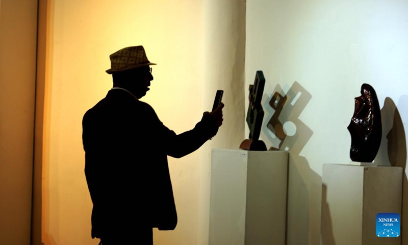 A visitor takes photos of ceramic works at a ceramics exhibition organized by Iraqi Plastic Artists Society in Baghdad, Iraq, Oct. 28, 2023. (Photo: Xinhua)