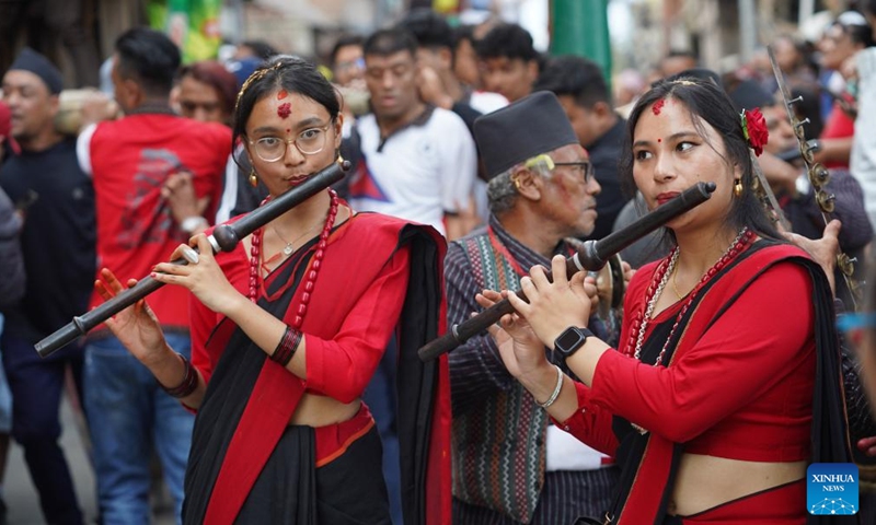 Women in traditional attire play the flutes during the Hadigaun festival in Kathmandu, Nepal, Oct. 29, 2023. The Hadigaun festival is celebrated every year after the Dashain festival. (Photo: Xinhua)