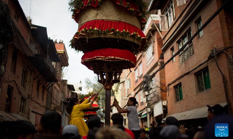 People carry and rotate a traditional chariot to celebrate the Hadigaun festival in Kathmandu, Nepal, Oct. 29, 2023. The Hadigaun festival is celebrated every year after the Dashain festival. (Photo: Xinhua)