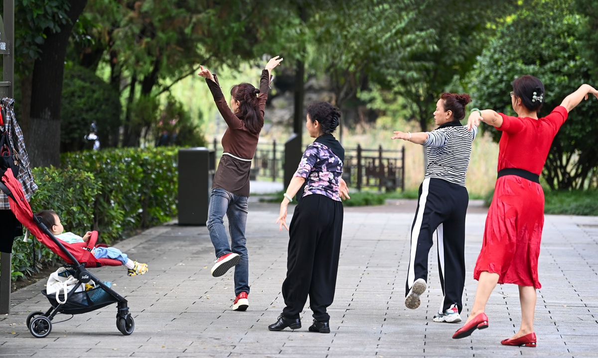 Several citizens dance to the music inside a square in Xi'an, Northwest China's Shaanxi Province. Photo: VCG