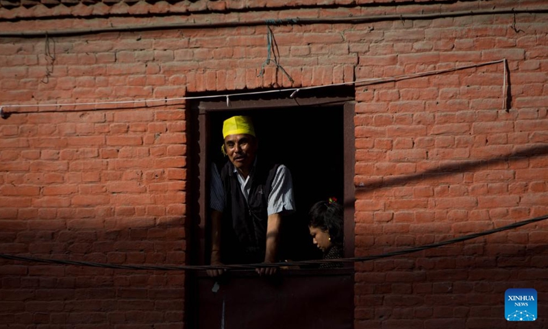 A man watches the celebration of the Hadigaun festival in Kathmandu, Nepal, Oct. 29, 2023. The Hadigaun festival is celebrated every year after the Dashain festival. (Photo: Xinhua)