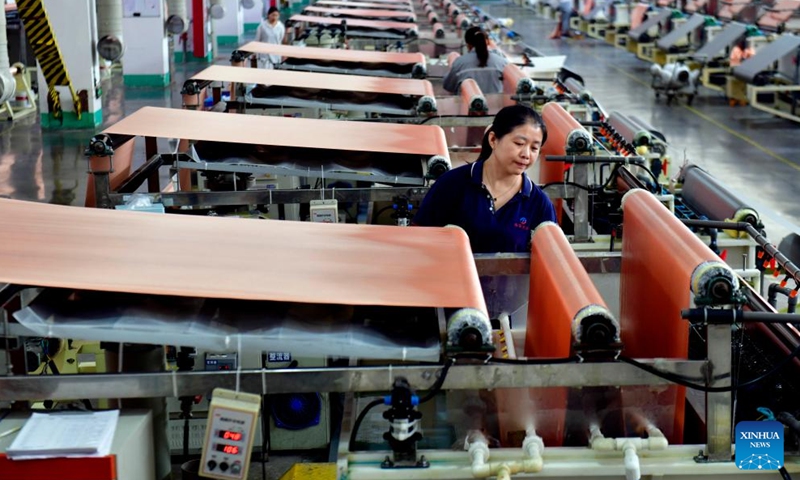 Staff members work at a new material company in Dingtao District of Heze City, east China's Shandong Province, Oct. 29, 2023. In recent years, Dingtao District of Heze City has continuously developed characteristic industries including biomedicine industry and new materials, so as to promote high-quality economic development. (Photo: Xinhua)