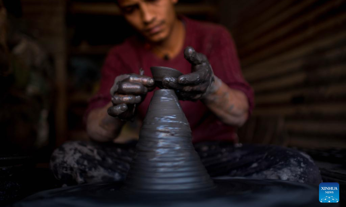 A worker makes a clay pot for Tihar, the Hindu festival of lights, in Bhaktapur, Nepal, Nov 10, 2023. This clay pot is used as an oil lamp during Tihar. Photo:Xinhua