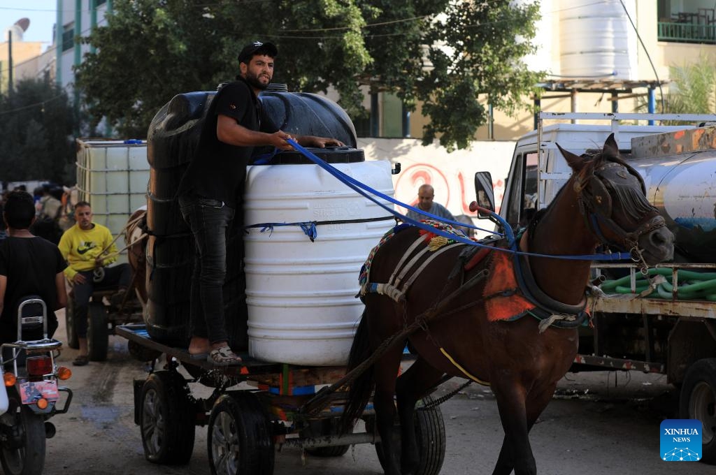 A man uses donkey-drawn cart to transport water in the southern Gaza Strip city of Khan Younis on Oct. 30, 2023. The Palestinian Islamic Resistance Movement (Hamas) launched a surprise attack on Israel on Oct. 7, firing thousands of rockets and infiltrating Israeli territory, to which Israel responded with massive airstrikes and punitive measures, including a siege on the enclave with supplies of water, electricity, fuel, and other necessities being cut off.(Photo: Xinhua)