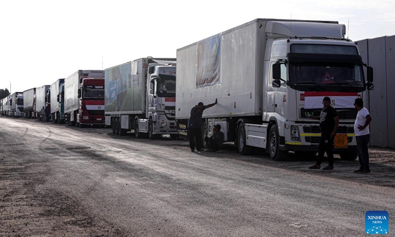 Trucks carrying relief aid line up to enter Gaza near the Egyptian side of the Rafah crossing, on Oct. 31, 2023. Hundreds of trucks carrying relief aid have waited for days at the Egyptian side of the Rafah crossing to enter the war-torn Gaza Strip, home to 2.3 million Palestinians who have been deprived of fuel, food, water and medical supplies for nearly three weeks under Israeli blockades.(Photo: Xinhua)