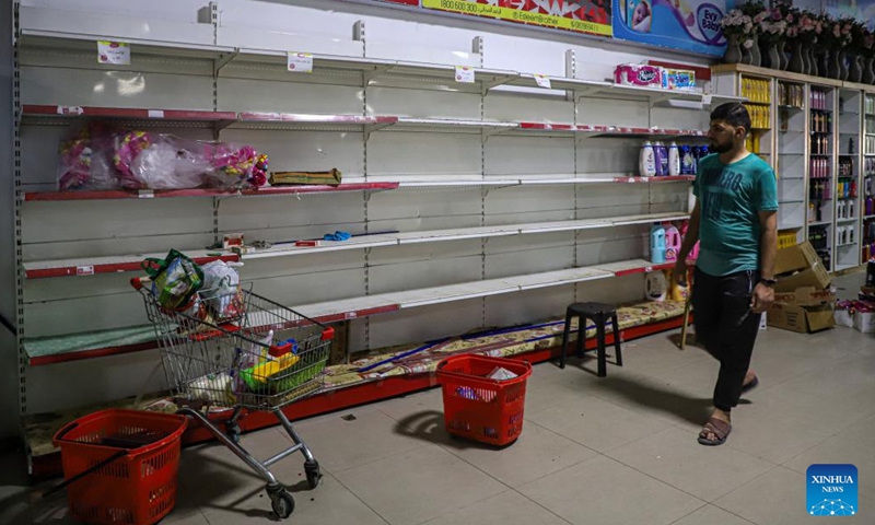 A man shops at a supermarket in the southern Gaza Strip city of Khan Younis, on Nov. 2, 2023. The Palestinian Islamic Resistance Movement (Hamas) launched a surprise attack on Israel on Oct. 7, firing thousands of rockets and infiltrating Israeli territory, to which Israel responded with massive airstrikes and punitive measures, including a siege on the enclave with supplies of water, electricity, fuel, and other necessities being cut off.(Photo: Xinhua)