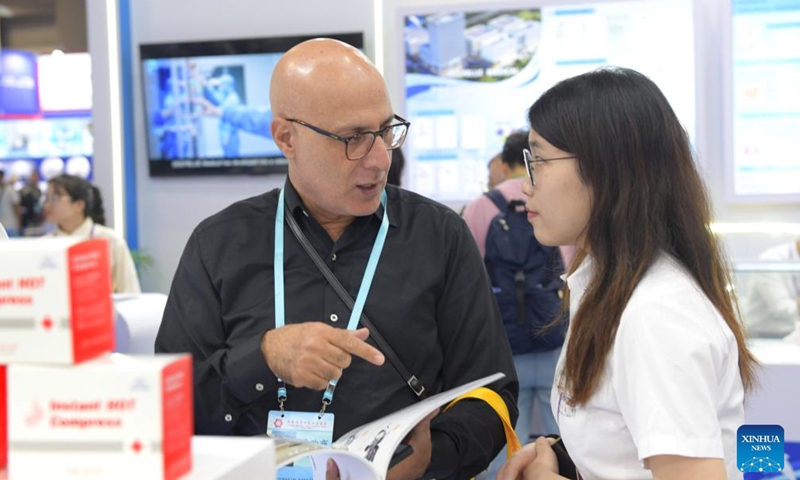 Visitors negotiate during the 134th Canton Fair in Guangzhou, south China's Guangdong Province, Nov. 4, 2023. The 134th session of the China Import and Export Fair, also known as the Canton Fair, closed here on Saturday. (Photo: Xinhua)