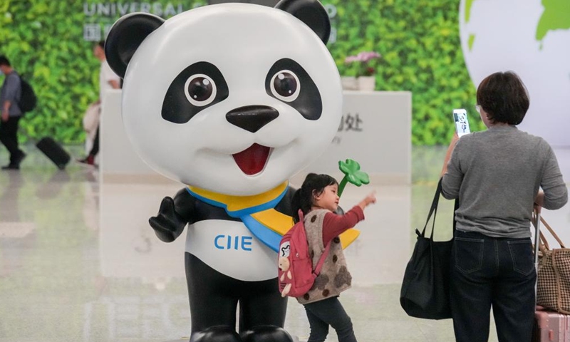 A child poses for photos with Jinbao, mascot of the China International Import Expo (CIIE), at Shanghai Hongqiao Airport in Shanghai, east China, Nov. 3, 2023. The 6th China International Import Expo (CIIE) is scheduled to be held in Shanghai from Nov. 5 to 10. The expo showcases China's new development paradigm, a platform for high-standard opening up, and a public good for the whole world. (Photo: Xinhua)