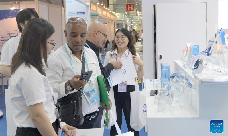 Visitors negotiate during the 134th Canton Fair in Guangzhou, south China's Guangdong Province, Nov. 4, 2023. The 134th session of the China Import and Export Fair, also known as the Canton Fair, closed here on Saturday. (Photo: Xinhua)