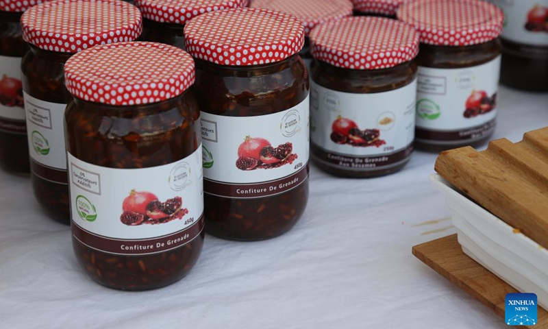 This photo taken on Nov. 4, 2023 shows bottles of jam made from pomegranate at a pomegranate festival in Testour, Tunisia. (Photo: Xinhua)