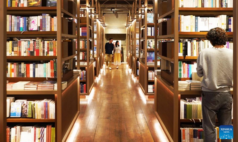 People visit a bookstore in Changning District of Shanghai, east China, Nov. 3, 2023. The 6th China International Import Expo (CIIE) is scheduled to be held in Shanghai from Nov. 5 to 10. The expo showcases China's new development paradigm, a platform for high-standard opening up, and a public good for the whole world. (Photo: Xinhua)