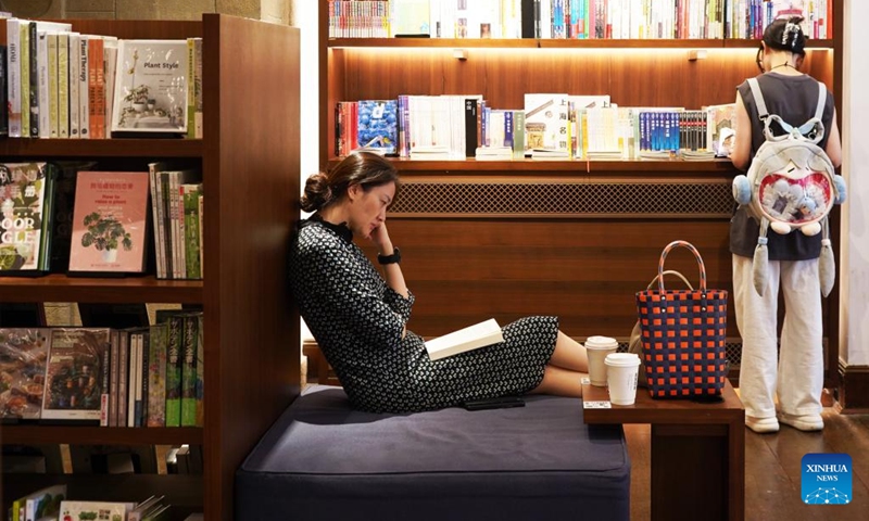 People read books at a bookstore in Changning District of Shanghai, east China, Nov. 3, 2023. The 6th China International Import Expo (CIIE) is scheduled to be held in Shanghai from Nov. 5 to 10. The expo showcases China's new development paradigm, a platform for high-standard opening up, and a public good for the whole world. (Photo: Xinhua)