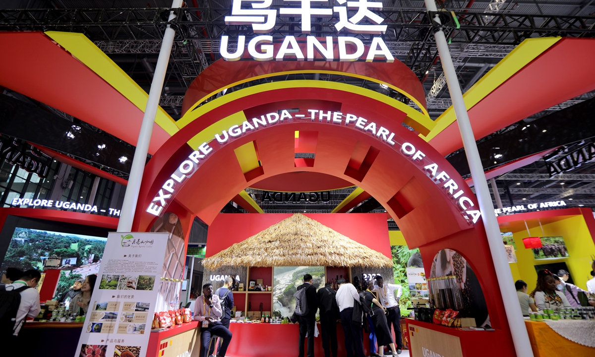 Visitors are attracted by products showcased at the  Uganda Pavilion at the 6th China International Import Expo (CIIE) held in Shanghai on November 9, 2023. This year, 69 countries and three international organizations participated in the Country Exhibition at this year's CIIE, including developed countries, developing countries and least-developed countries across the globe.Photo: Chen Xia/GT