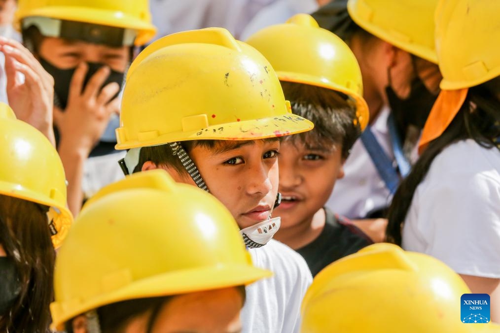 Students wearing hard hats participate in a nationwide simultaneous earthquake drill at a school in Quezon City, the Philippines, Nov. 9, 2023.(Photo: Xinhua)