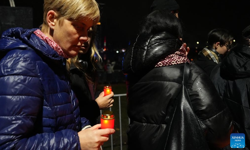 People gather to light candles during an event to mark the Latvian Freedom Fighters Remembrance Day, or Lacplesis Day, in Riga, Latvia, Nov. 11, 2023. (Photo: Xinhua)