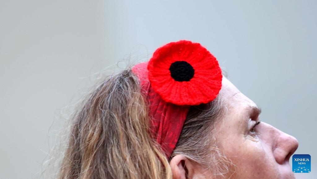 A woman is seen with poppy headwear in front of the Cenotaph on Whitehall on the occasion of Remembrance Sunday in London, Britain, on Nov. 12, 2023. Remembrance Sunday is an annual commemoration held on the closest Sunday to Armistice Day, Nov. 11, the anniversary of the end of the First World War.(Photo: Xinhua)