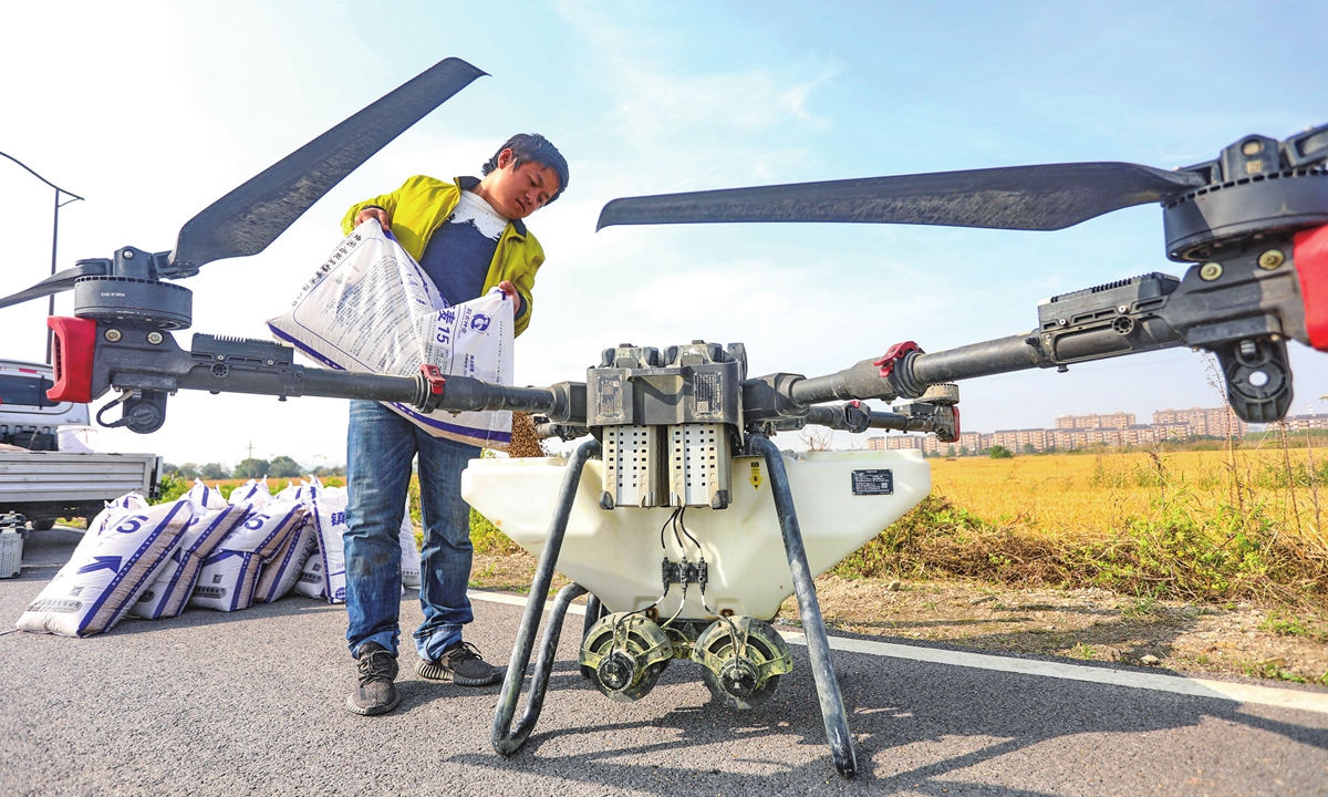 A farmer pours wheat seeds into a drone at a farm in Jiaxing, East China's Zhejiang Province on November 15, 2023. With 95 percent of the winter wheat crop having been sown nationwide, farmers across the country are sowing crops, laying the foundation for the next year's harvest. Photo: VCG