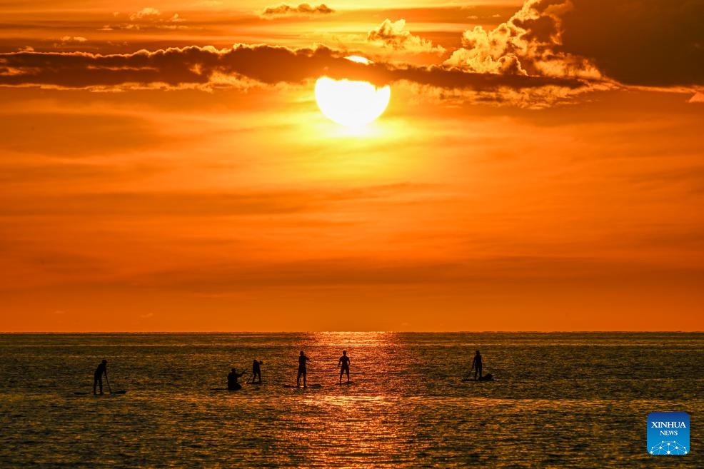 People enjoy themselves on the sea at sunset in Kota Kinabalu, Sabah, Malaysia, Nov. 14, 2023.(Photo: Xinhua)