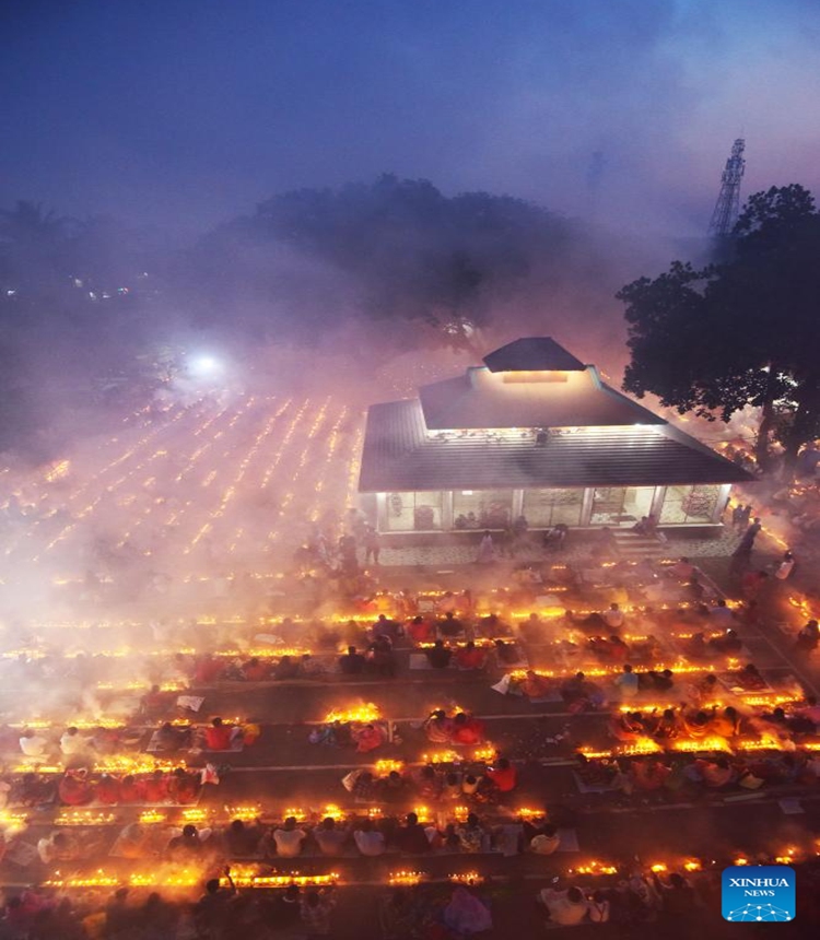 Devotees sit for prayer with burning incense and light oil lamps during the Rakher Upobash, a religious fasting festival, at a temple in Narayanganj, Bangladesh, on Nov. 14, 2023. (Photo: Xinhua)