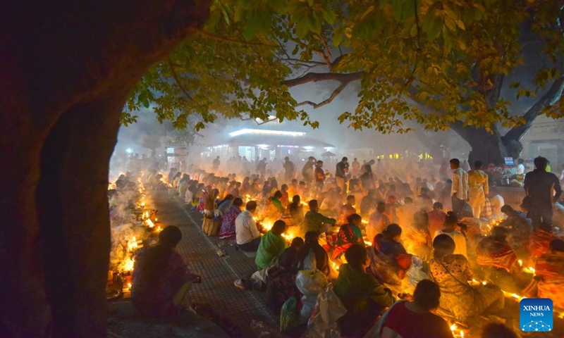 Devotees sit for prayer with burning incense and light oil lamps during the Rakher Upobash, a religious fasting festival, at a temple in Narayanganj, Bangladesh, on Nov. 14, 2023. (Photo: Xinhua)