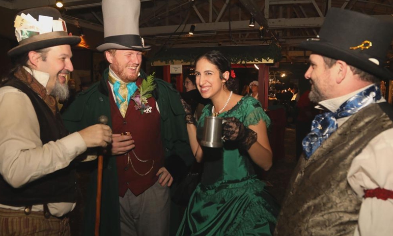 People wearing costumes of the Victorian era take part in the Great Dickens Christmas Fair in San Francisco, the United States, Nov. 18, 2023. The Great Dickens Christmas Fair, which was first held in 1970, opened in San Francisco on Saturday. The fair is aimed at attracting people to enjoy the culture of the Victorian era by recalling the characters and scenes in the works of British novelist Charles Dickens. (Photo: Xinhua)
