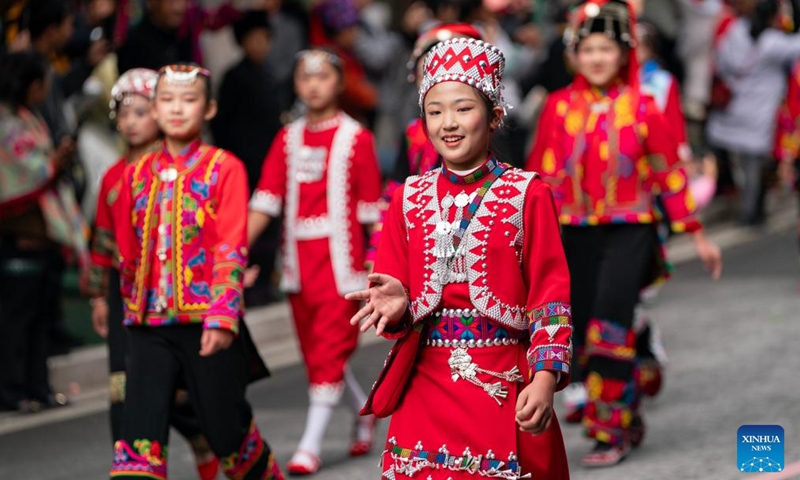 Local residents of Hani ethnic group attend a parade during a cultural tourism festival in Luchun County of Honghe Hani and Yi Autonomous Prefecture, southwest China's Yunnan Province, Nov. 19, 2023. The long street banquet, a time-honoured tradition of Hani ethnic group in China, was held here during a cultural tourism festival on Sunday. (Photo: Xinhua)